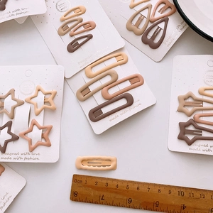 Matte beige and brown BB hair clips set in star and heart shapes on display cards
