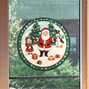 Detail of round Christmas window cling showing Santa Claus and penguin on glass