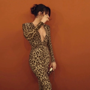 Dettaglio di abito lungo leopardato con scollo a V profondo e nodo elegante in vita