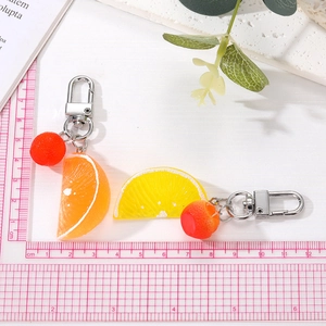 Realistic orange and lemon slice keychains with resin details and metal clasps