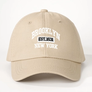 Close-up of white Brooklyn New York embroidery on khaki cotton twill baseball cap