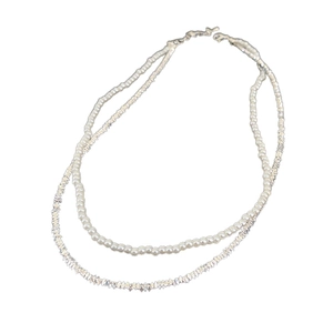 Double-layer necklace with white pearls and silver beaded chain in a retro fashion style