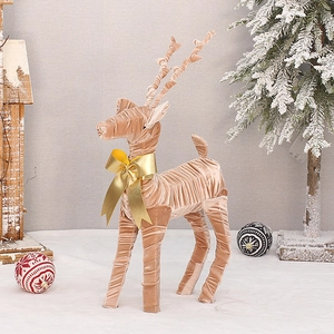 Champagne velvet reindeer decor with golden bow and spiral design for Christmas setting