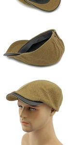 Detail of wool tweed flat cap with premium black leather brim and retro texture