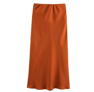 Detail of satin texture and glossy finish on dark orange midi skirt for women