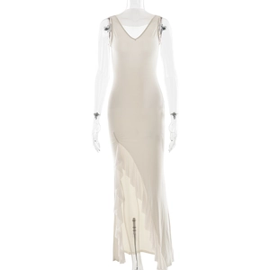 Detail view of the beige V-neck long dress featuring an asymmetric ruffled hemline