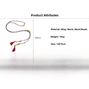 Detail view of ethnic red braided rope waist chain with wooden beads and red tassel fringe