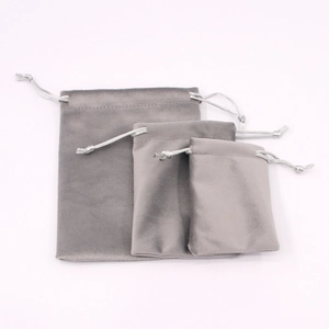 Three grey velvet drawstring bags in small, medium, and large sizes on white background