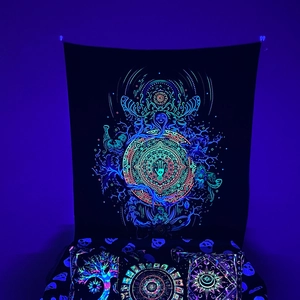 Detail of UV reactive blacklight tapestry with neon mandala and fluorescent pillows