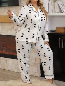 Detail of waffle-textured heart print pajamas set with black piping and button-down front