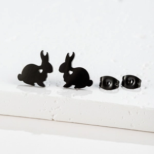 Detail of matte black rabbit earrings with hollow heart cut-outs and matching butterfly backs