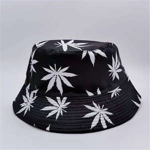 Close-up of leaf print texture on a black reversible bucket hat for sun protection