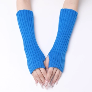 Detail of bright blue ribbed knit arm warmers with thumb holes on a white background