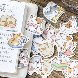 Cute cartoon cat stickers for DIY planners displayed on wood and notebook backgrounds