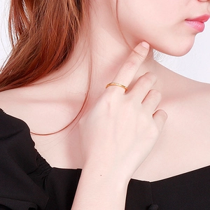 Close-up of a minimalist gold square ring with diamonds worn on a finger