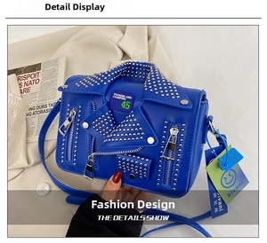 Macro detail of blue biker jacket crossbody bag featuring silver studs and metal zippers