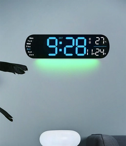 Digital wall clock with blue LED numbers, date display and green ambient lighting