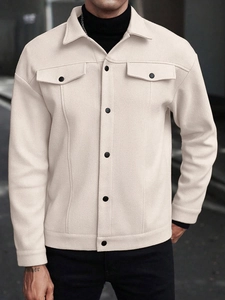 Detail of men's beige fleece shirt jacket featuring button pockets and textured fabric