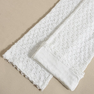Detail of white textured fabric showing high-quality stitching on a summer backless set