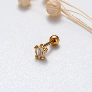 Macro shot of gold crown cartilage stud with cubic zirconia and screw ball back