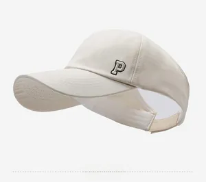 Detail of adjustable beige ponytail baseball cap with embroidered P letter on side