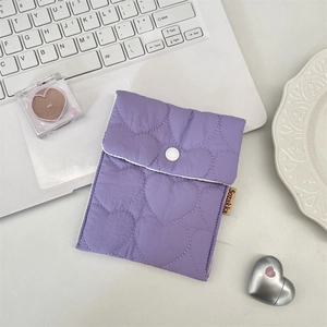 Detailed view of lavender quilted heart pouch with a white snap button closure
