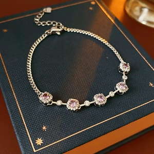 Close-up of square purple zircon bracelet with adjustable chain on blue jewelry box