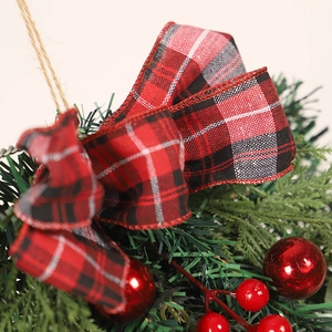 Eucalyptus Christmas swag with red berries and black-red plaid bow for door decor