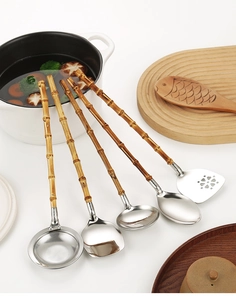 Detailed close-up of 304 stainless steel kitchen utensils with natural bamboo handles