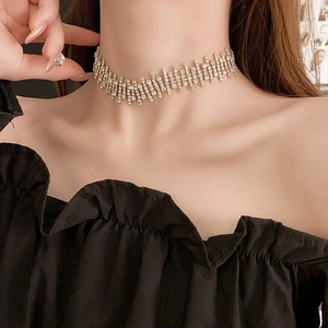 Close-up of sparkling diamond irregular fringe necklace worn on model neck