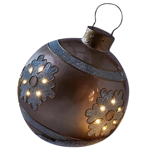 Close-up of bronze inflatable Christmas ball with LED lights and snowflake patterns