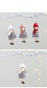 Detailed view of handmade Christmas angel ornaments with plush fabric and metal bells