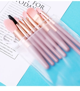 Detailed view of 8 soft pink makeup brushes neatly stored in a matte translucent zipper pouch