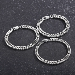 Minimalist silver stainless steel Cuban link bracelets with lobster clasp on dark background