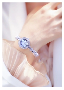 Close-up of elegant silver women watch with rhinestone chain strap on a model wrist