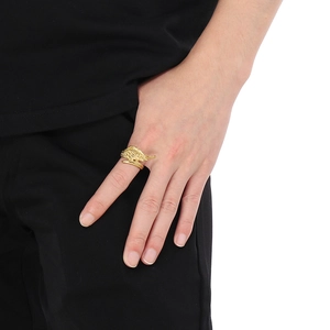 Detail shot of vintage golden angel wing feather ring worn on a finger