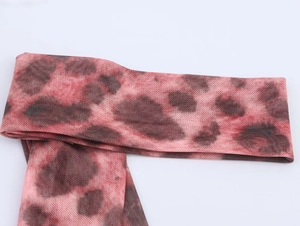 Close-up of pink leopard print mesh fabric texture with high-quality netting detail