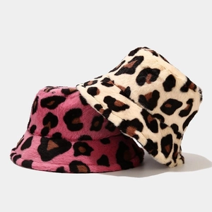 Close-up of leopard print faux fur bucket hats in rose pink and cream white textures
