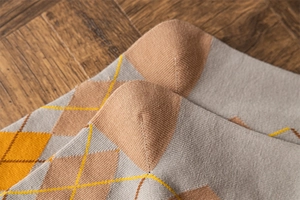 Macro shot of argyle pattern socks showing reinforced heel and high-quality cotton knit