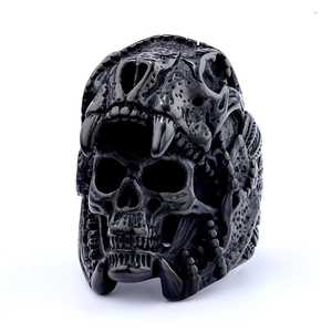 Macro shot of matte black punk skull ring with dual layer animal and human bone texture