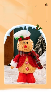 Detail of Christmas gingerbread man doll in red knitted jacket and chef hat decor