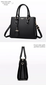 Detailed side view of black lychee leather handbag with golden hardware and shoulder strap