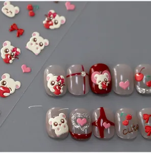 Detail of 3D embossed nail stickers featuring cute white bears and red cherry designs