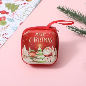 Close-up of red tinplate Christmas coin purse with Santa illustration and wrist strap