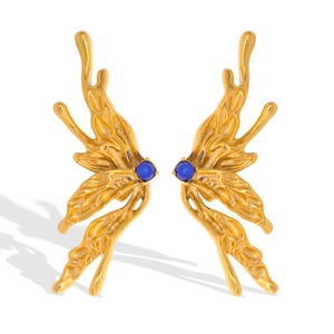 Macro shot of gold butterfly wing earrings with blue natural stone in a modern liquid style