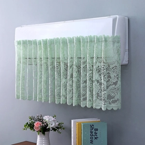 Close-up of light green lace air conditioner cover with floral patterns and wavy edges