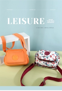 Detail view of water-resistant nylon shoulder bags in bright orange and splash ink patterns