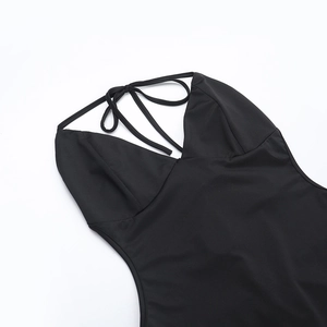 Detail of black halter neckline and backless tie design on slim-fit sexy jumpsuit