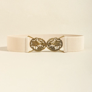 Detail of vintage bronze buckle with crane carvings on beige elastic waist belt