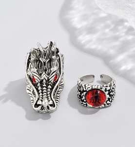Detailed view of vintage dragon head ring and red evil eye ring with adjustable bands